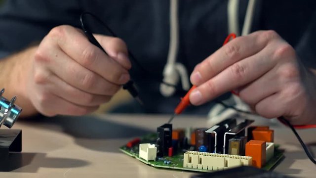 Electrical is testing with voltmeter for repair electronic equipment