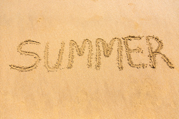 Summer word written on beach sand