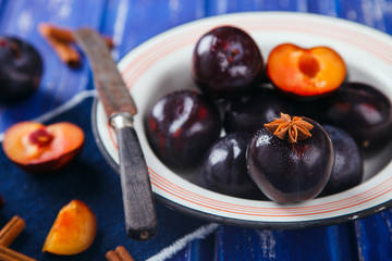 Plum metal plate on a blue background. selective focus.