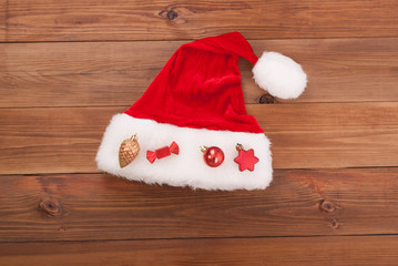 Obraz na płótnie Canvas Santa hat Claus with toys on wooden background.