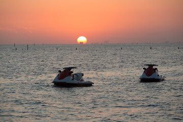 Sunset with motor boat in Biloxi beach, Mississippi, 