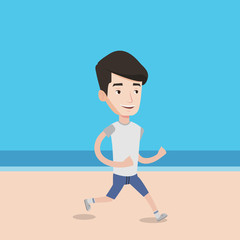 Young sporty man jogging on the beach.