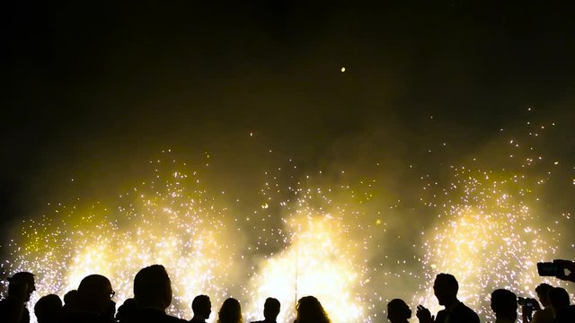 silhouettes of people on a background of new year fireworks.