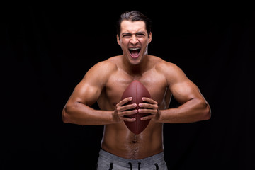 Fototapeta na wymiar Ripped muscular man with american football