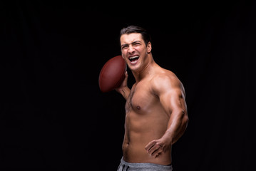 Ripped muscular man with american football