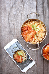 Taking a photo of kimchi noodle soup  with smart phone