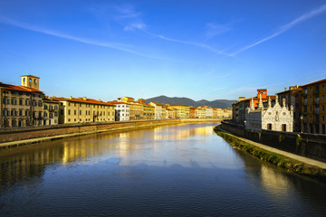 Pisa, Arno river sunset. Lungarno and Spina small church. Italy