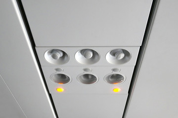 Close up of overhead console in the modern passenger aircraft.air conditioner button and lighting switch