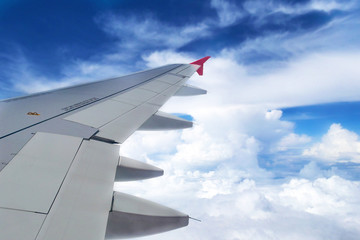Fototapeta premium Looking through window aircraft during flight in wing with a nice blue sky