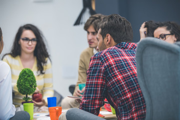Group of young business professionals having a meeting.