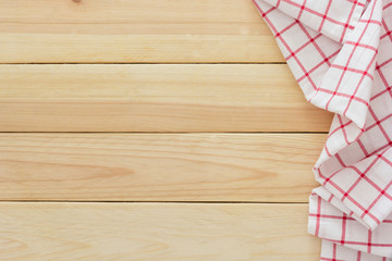 Tablecloth textile, checkered picnic napkin on wooden table background, Top view with blank space and text.