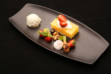 Strawberry cheesecake served with fruit and vanilla ice cream