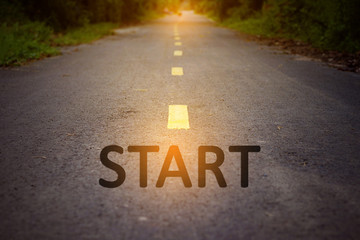 Concept of way to successful with Starting point, Asphalt road with path, Roadside tree, Sunlight. Selective focus.