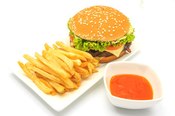 tasty hamburger, French fries and chili sauce on white plate, Fast food with copy space