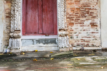 Ancient big windows with Old brick wall in a background image.The walls of ancient temples are older than 200 years,Thailand