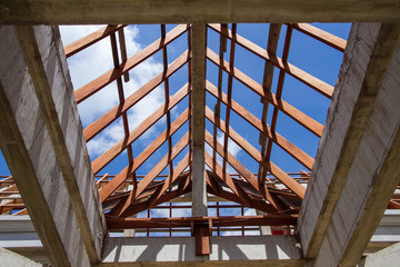 Low angle view of roof trusses and framing wooden of new house c