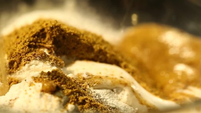 Pouring Beer into a Glass Bowl with Spices and White Flour