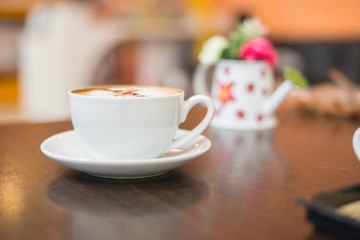 Cup of cappuccino at coffee shop background.