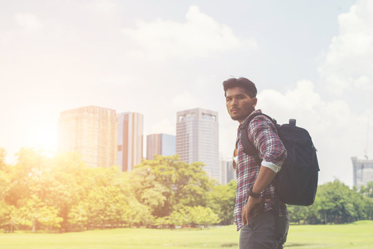 Portrait of young hipster man enjoy the town view from park, bef