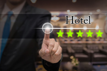 Businessman pointing five star button to increase rating of hote