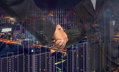 Hand shake between businessman on Trading graph on the cityscape