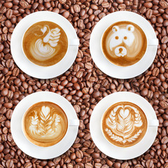 Latte art coffee on roasted coffee beans background