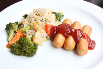  Fried rice and sausage on white dish.