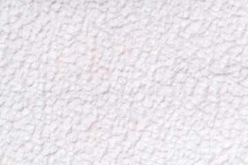 White fluffy background of soft, fleecy cloth. Texture of textile closeup.