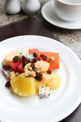 Fruit salad on white dish.
