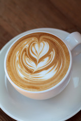 Close-up latte art coffee on wood