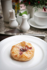 dessert baked or fruit bread on white dish.