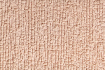 Light brown fluffy background of soft, fleecy cloth. Texture of textile closeup.