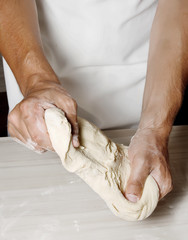 Hands kneading a dough