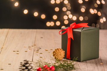 christmas decorations and green present on wood.