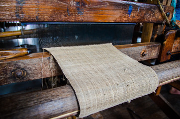 Close up of bamboo threads weaving on the manual wood loom