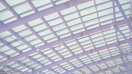 Magenta and blue futuristic abstract glass and steal ceiling receding into the distance with...