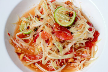 Green Papaya Salad (Som tum Thai) on table. Thai cuisine spicy delicious.