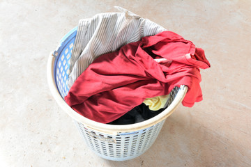 Shirts and t-shirts in the basket of clothes