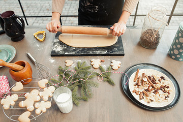 Kitchen table with dough rolling out. Preparing Christmas traditional treats. winter holidays, xmas spirit, culinary, home cuisine concept