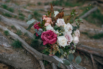 big fluffy wedding bouquet with silk ribbon on the roots of oak