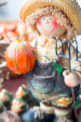 Farmer figurine with pumpkin and nuts. Halloween decoration. 