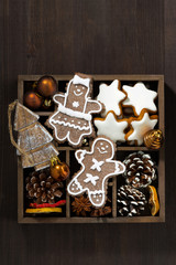 Christmas symbols in a wooden box on dark wooden table, vertical