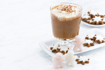 festive pumpkin latte and almond cookies on a white background