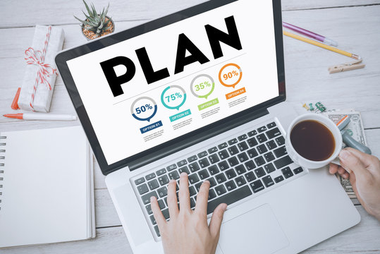business hand typing on a laptop keyboard with Plan homepage on the computer screen planning business strategy data analysis concept.