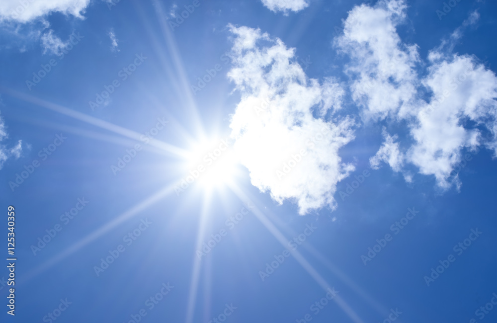 Wall mural beautiful blue sky sunbeams and clouds with sun rays nature back