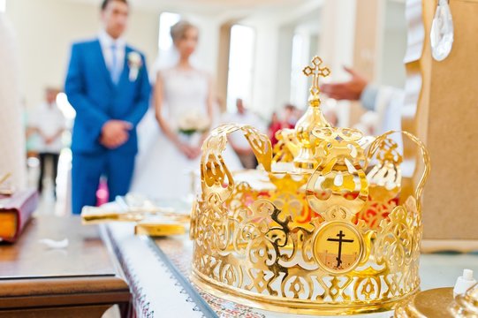 wedding crown at church background newlyweds