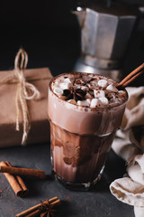 Cocoa or latte or hot chocolate with marshmallow and flavored with cinnamon. On a gray concrete background. Christmas present. Christmas concept. Christmas holiday.