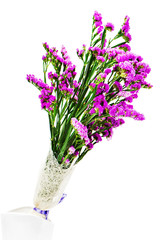 Bouquet from purple statice flowers in vase isolated on white background. Closeup.