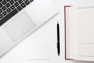 Laptop keyboard, pen and notebook flat lay. Top view on successful businessman work accessories, free space.