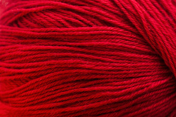Red knitting thread texture, handiwork backdrop. Bright handiwork background, crochet woolen string, Leisure, hobby, needlework concept